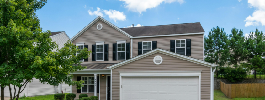 Exterior of a home that has been upgraded with new beige vinyl siding